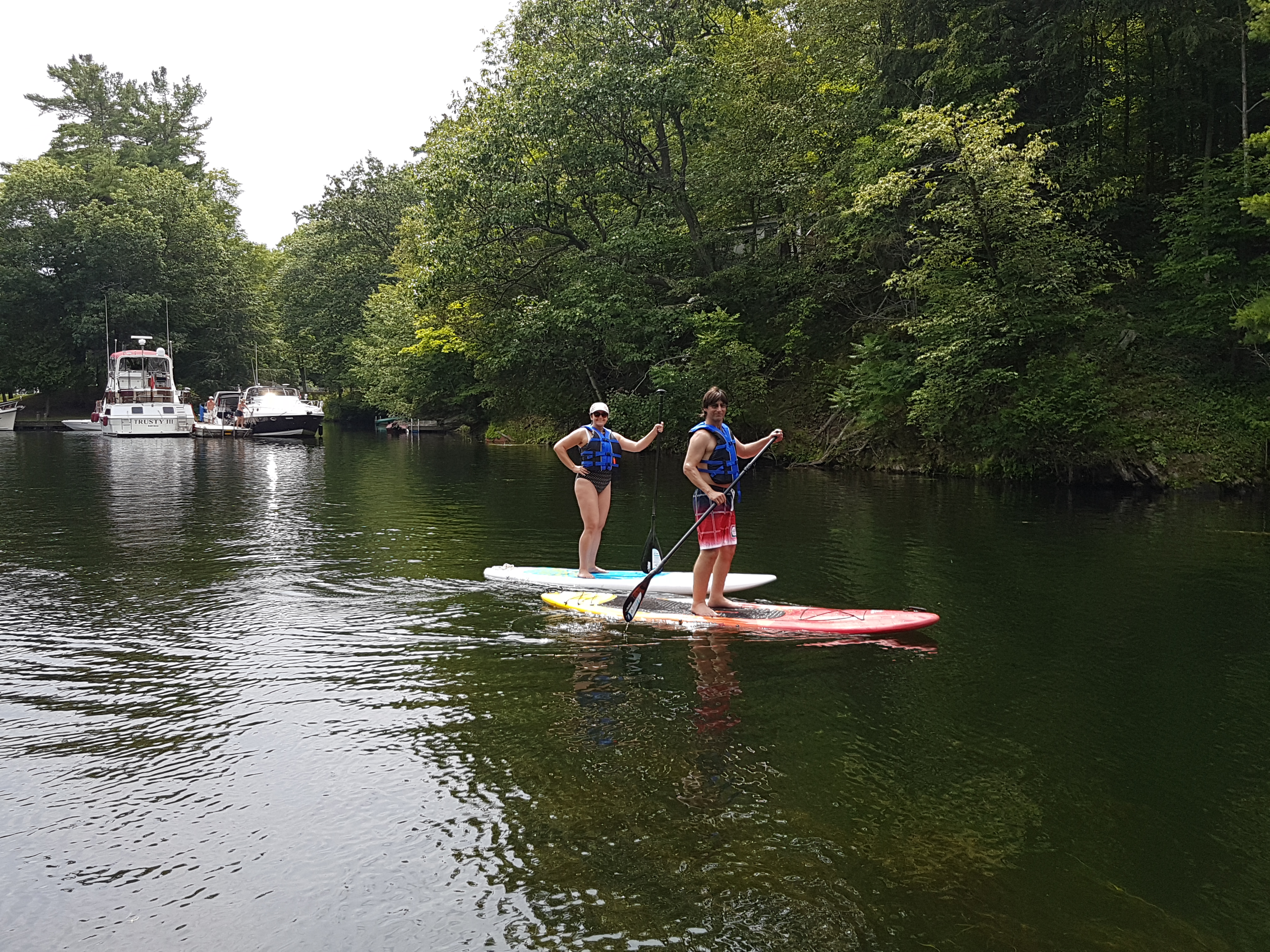 Image of two people on paddle boards.